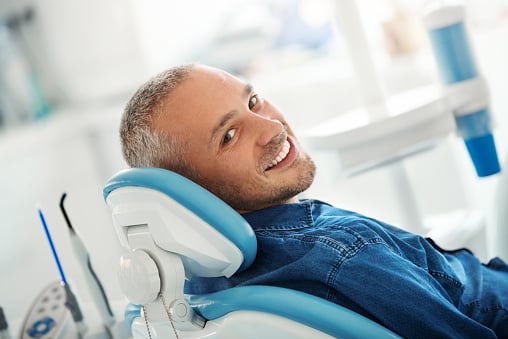 Male patient smiling at dental implant consultation at Virginia Surgical Arts in Virginia Beach, VA