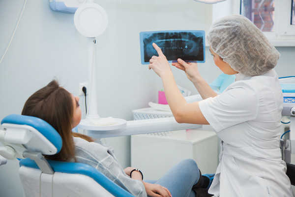 Oral Surgeon explaining dental x-rays during sinus lift consultation at Virginia Surgical Arts in Virginia Beach, VA Oral Surgeon explaining dental x-rays during sinus lift consultation at Virginia Surgical Arts in Virginia Beach, VA