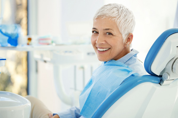 Older woman smiling and waiting for oral surgeon before sinus lift at Virginia Surgical Arts in Virginia Beach, VA
